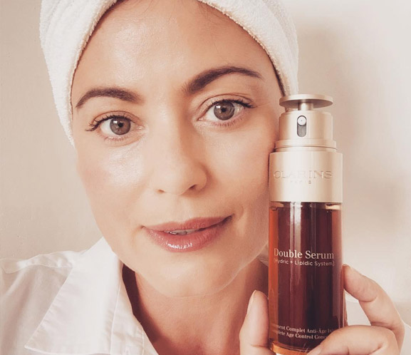 Clarins user holding Double Serum by face