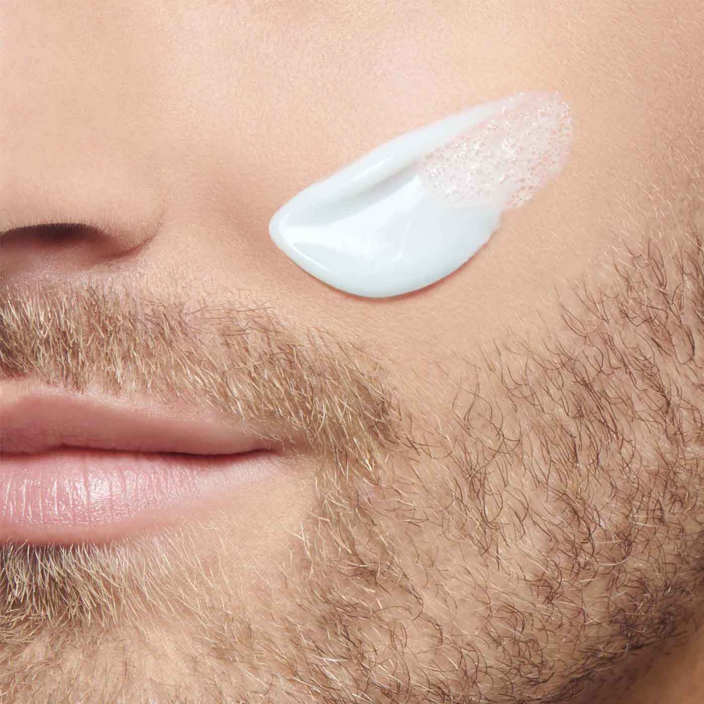 Close up of a man's face with face cream Close up of a man's face with face cream